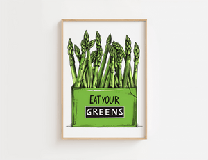 Køkkenplakat med grønne asparges og teksten "Eat Your Greens" i en træramme – sjov og farverig vægdekoration til køkkenet.