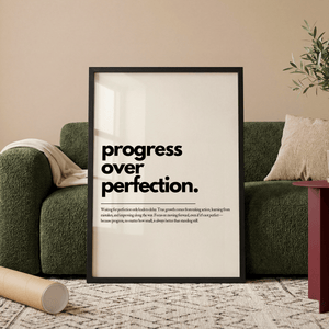 Motiverende plakat med teksten progress over perfection i minimalistisk sort typografi.