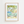 Framed art print of a limoncello bottle, lemon tree, glass of limoncello, and Italian villa in warm summer tones, styled like a vintage poster.