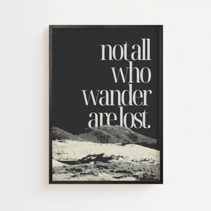 Not all who wander plakat med citat i serifskrift over bjerglandskab i sort og hvidt, sort ramme