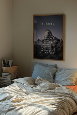 Success bjerg plakat med typografi i egetræsramme over seng